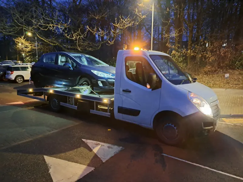 Recovery truck collecting a scrap car in Preston